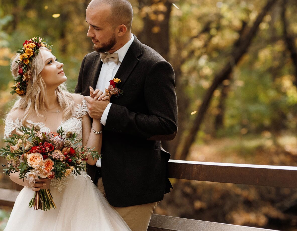 DIY wedding flowers for fall, featuring a bouquet and floral crown with coral garden roses, scabiosa pods, olive leaf, waxflower and chrysanthemums.