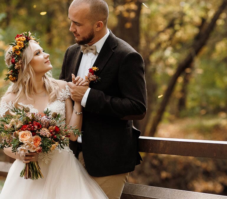 DIY wedding flowers for fall, featuring a bouquet and floral crown with coral garden roses, scabiosa pods, olive leaf, waxflower and chrysanthemums.