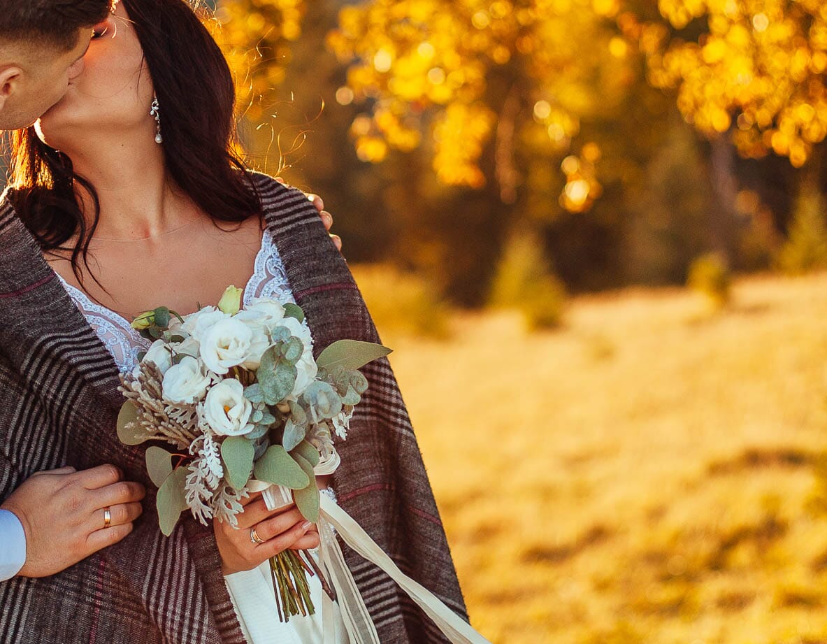 DIY wedding bouquet for a bride outdoors in fall, featuring lisianthus, eucalyptus, dusty miller, and silver brunia