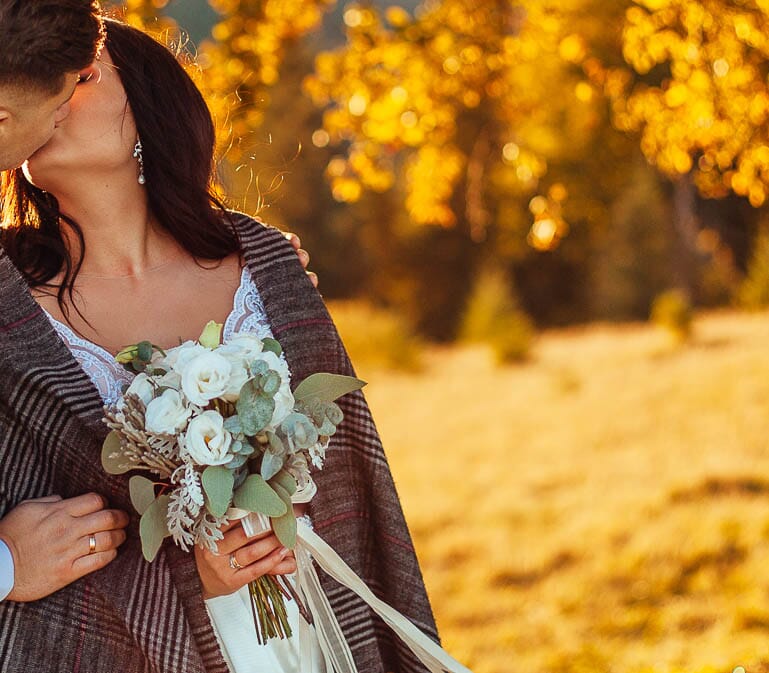 DIY wedding bouquet for a bride outdoors in fall, featuring lisianthus, eucalyptus, dusty miller, and silver brunia