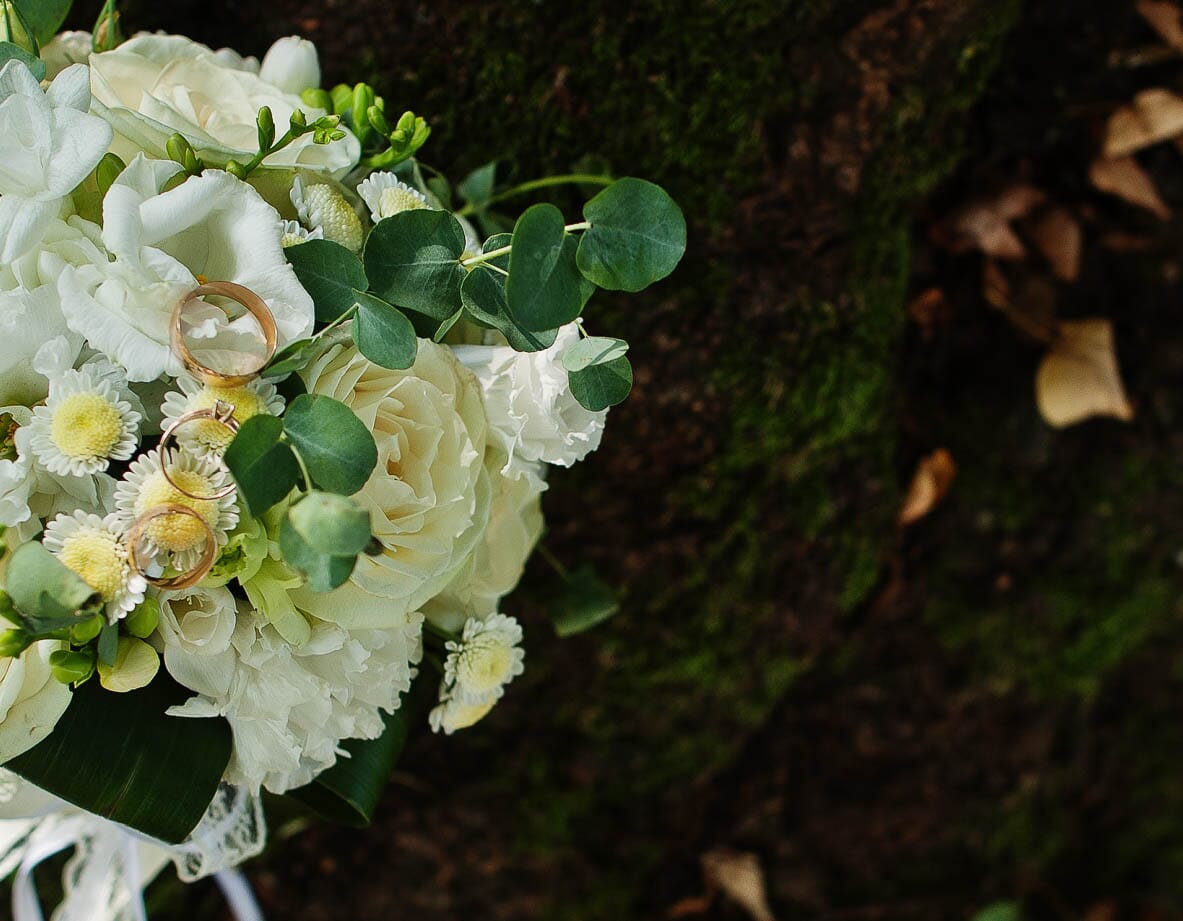 DIY wedding flowers with white roses, freesia, and mums.
