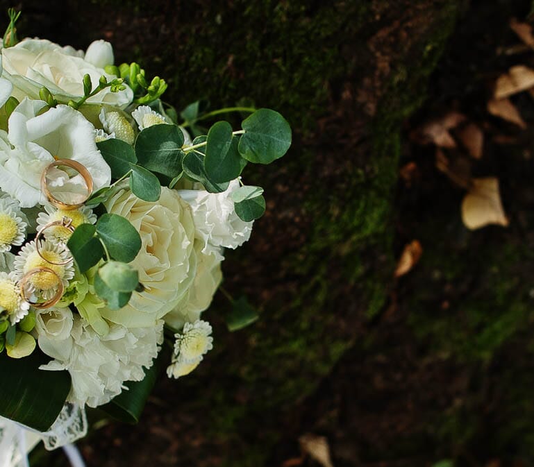 DIY wedding flowers with white roses, freesia, and mums.