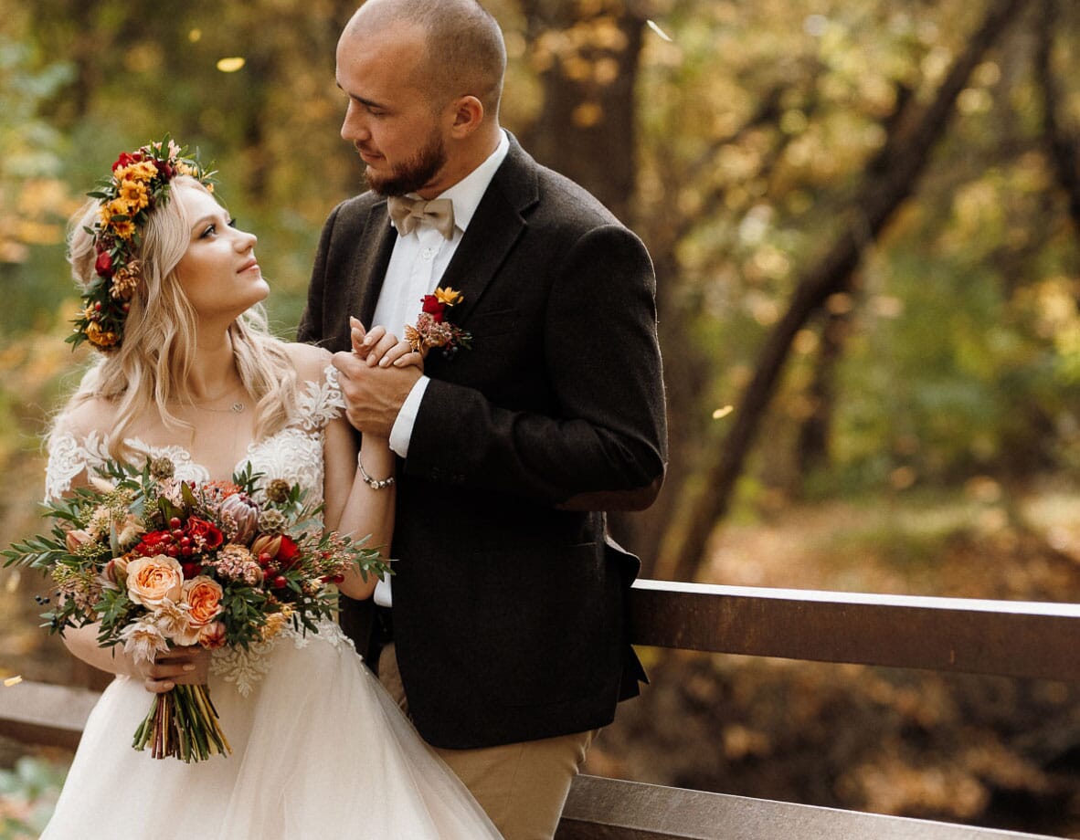 DIY wedding flowers for fall, featuring a bouquet and floral crown with coral garden roses, scabiosa pods, olive leaf, waxflower and chrysanthemums.