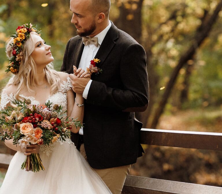 DIY wedding flowers for fall, featuring a bouquet and floral crown with coral garden roses, scabiosa pods, olive leaf, waxflower and chrysanthemums.