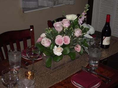 soft pink flowers in a rustic box